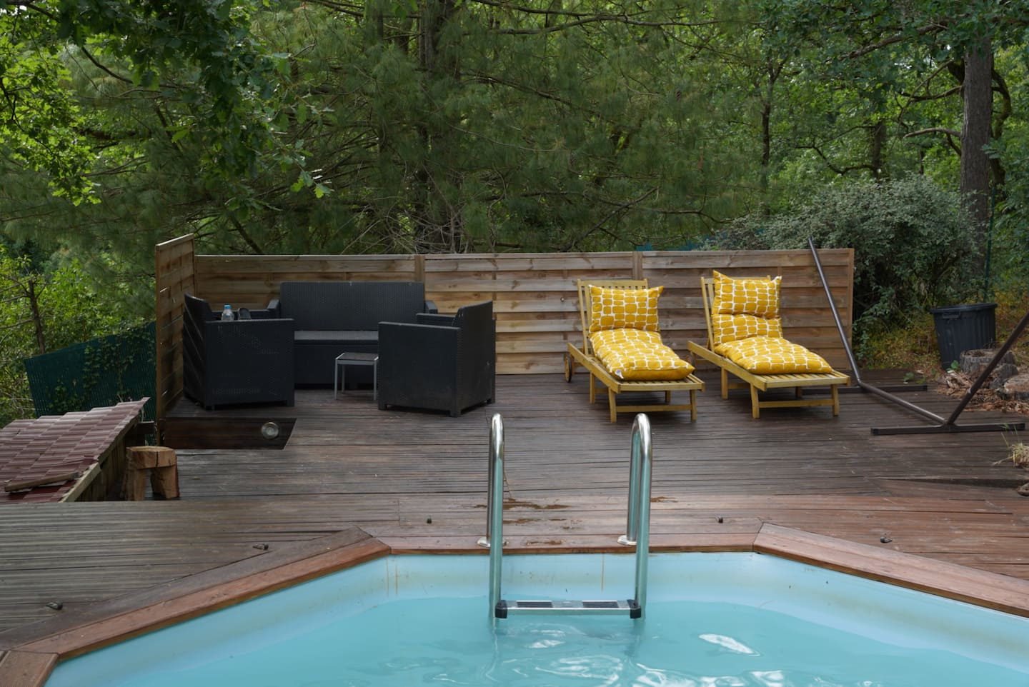 La piscine et ses transats sur la grande terrasse en bois